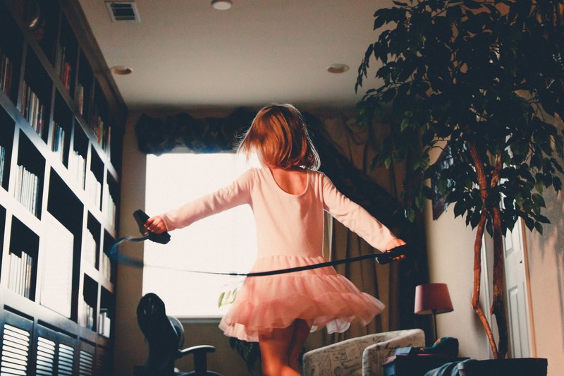 female child wearing a tutu getting ready to jump rope inside a reading room, child about to jump rope 4k