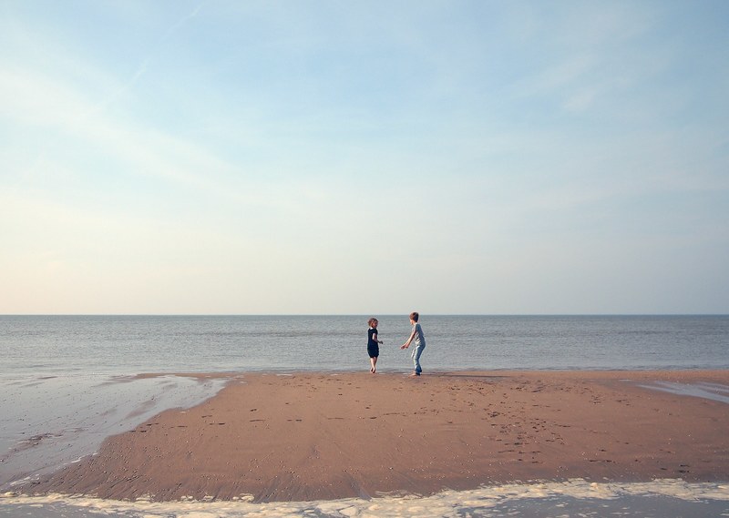 two beautiful kids enjoy play time on the beach shore, children enjoying the beach 4k