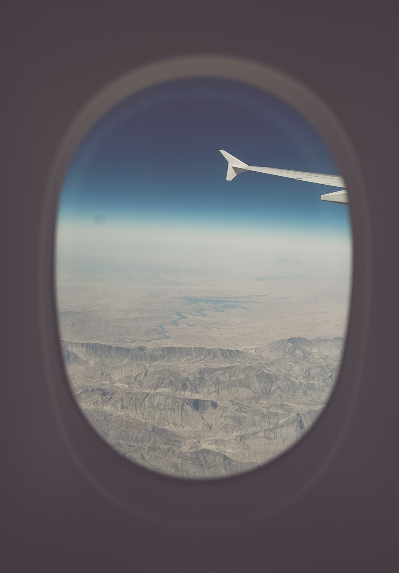 a remote mountain range in turkey seen from an airplane window, dry land 4k