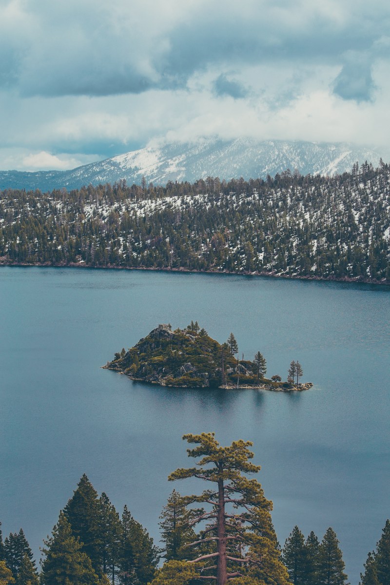 a small island in the middle of the tree lined lake tahoe, south lake tahoe 4k