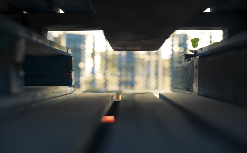 unique perspective of the city through wooden planks, out of focus city 4k