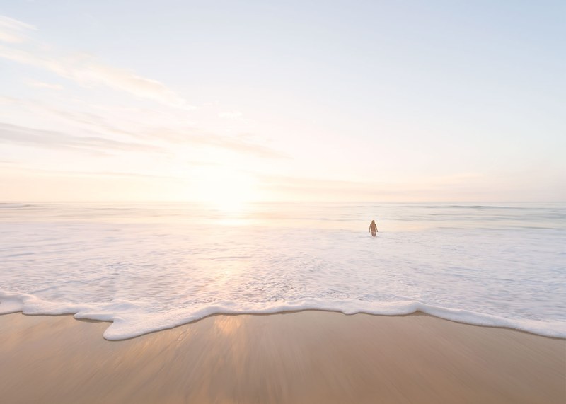 person entering the calm ocean at the sand beach in san diego, summertime in so cal 4k