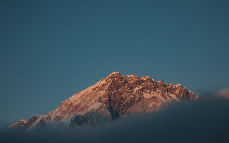 a jagged mountain ridge under a blue sky, always above 4k