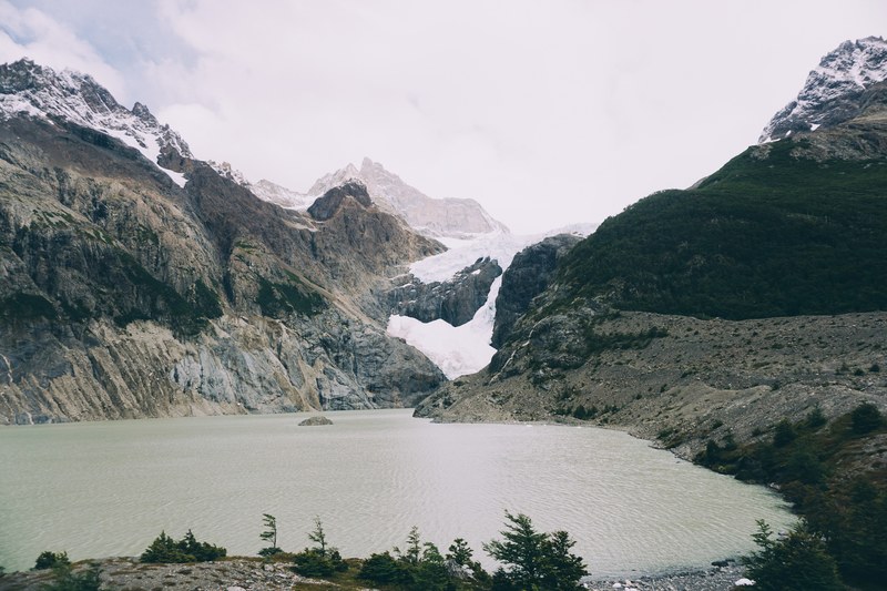 a lake near a mountain glacier in torres del paine national park, glaciar los perros 4k