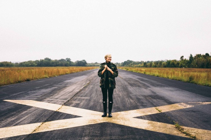 an older lady standing on the airfield at cornelia fort airport, cornelia fort airport 4k