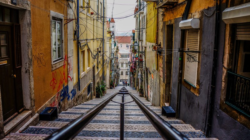 a staircase leading down an alley in lisbon, lisbon alley staircase 4k