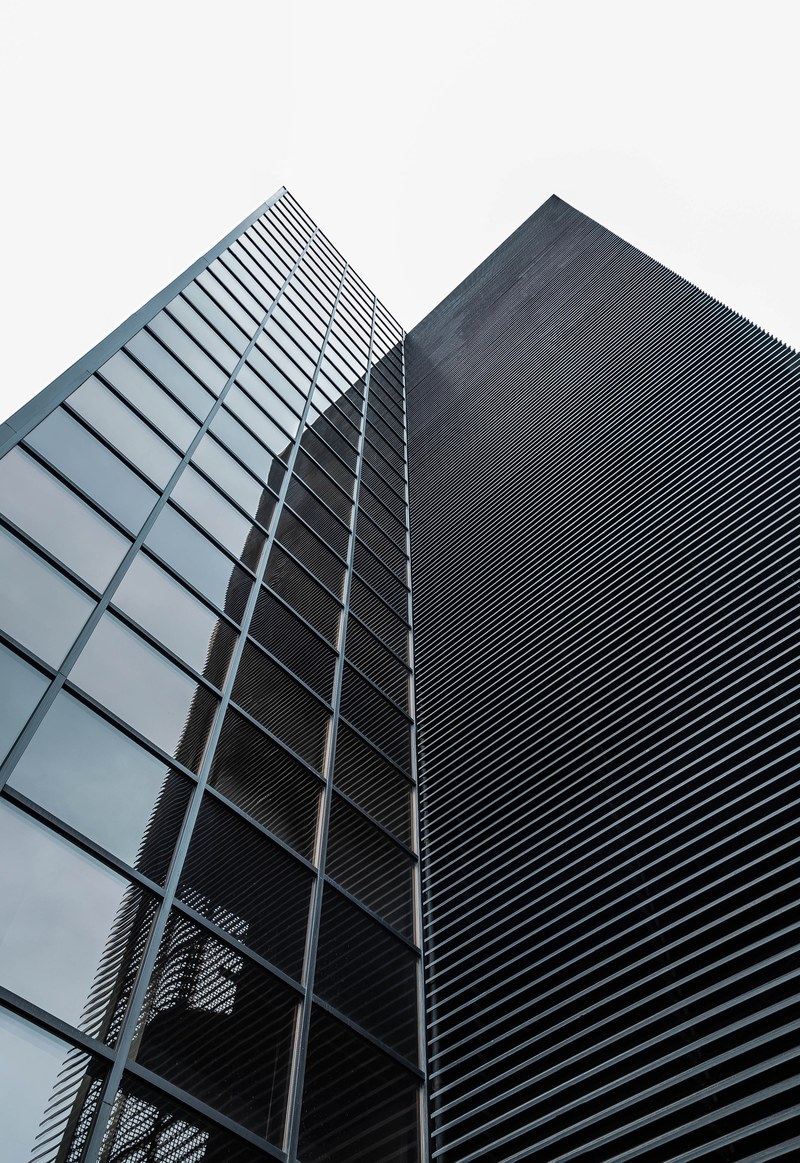 a corner of a modern office building facade with square glass windows, squares and lines 4k