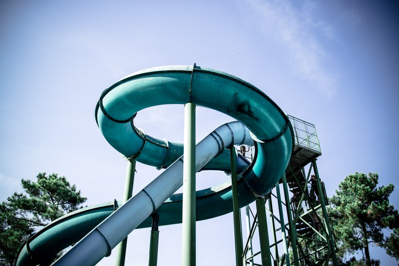 looking up at a blue and teal tube water slide in labenne, slip n slide 4k
