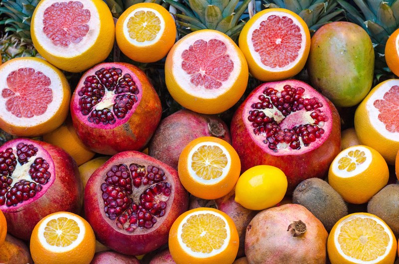 mango grapefruit pomegranate and tropical fruit sliced open, collection of fruits 4k