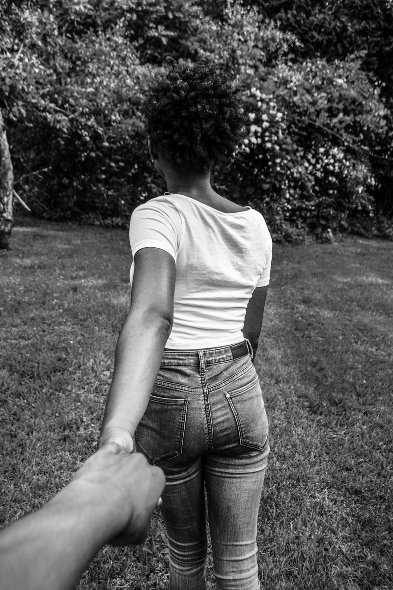 young woman walks away pulling her lover behind, with him in tow 4k