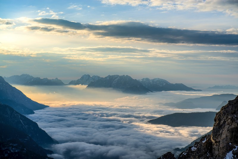 a high view of a sea of clouds covering a mountain valley in the dolomites, morning cloud 4k