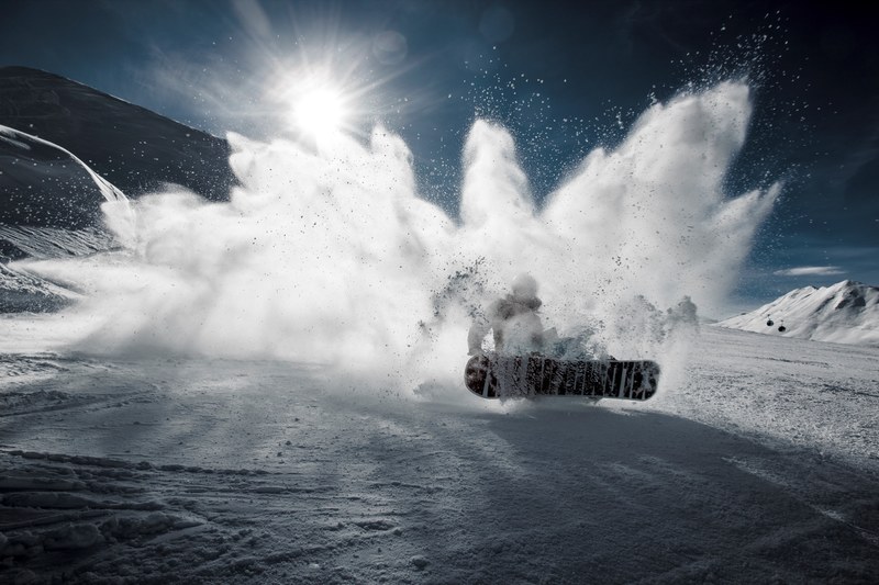 a snowboarder hitting the powdery snow hard in davos, snowboarder in davos 4k