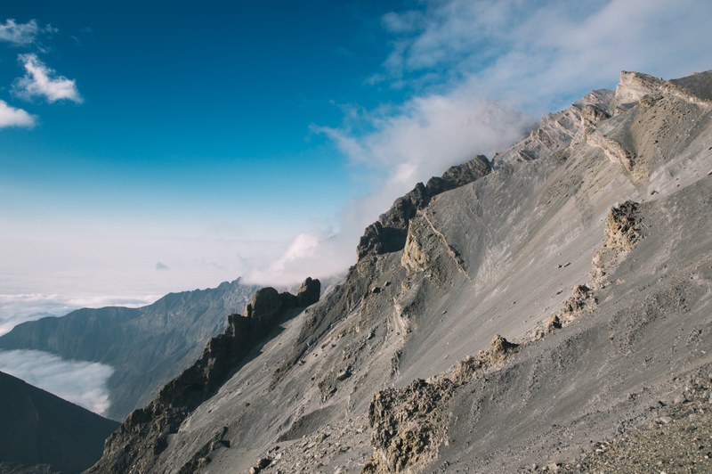 rocky mountain ridge near the beach against a blue sky, sunny mountain ridge 4k