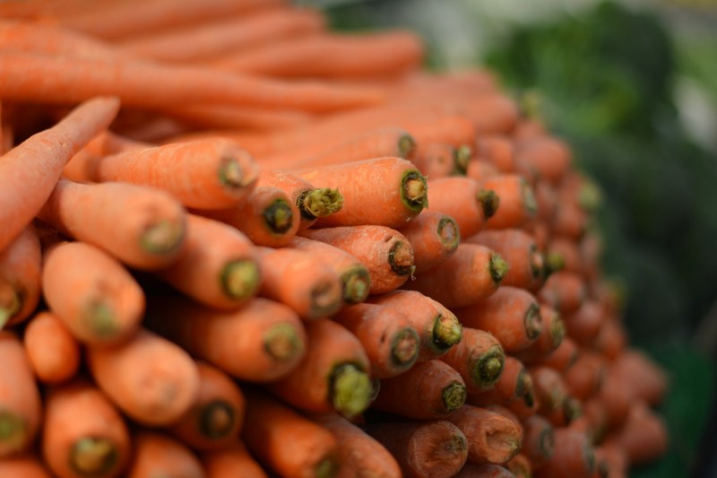 a close up shot of a neatly arranged pile of fresh carrots, carrot wall 4k