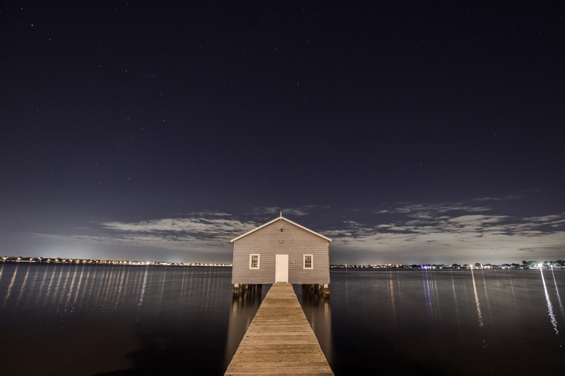 panoramic view from the jetty of a lakehouse with the cityscape in the background at night, _jetty lakehouse cityscape 4k