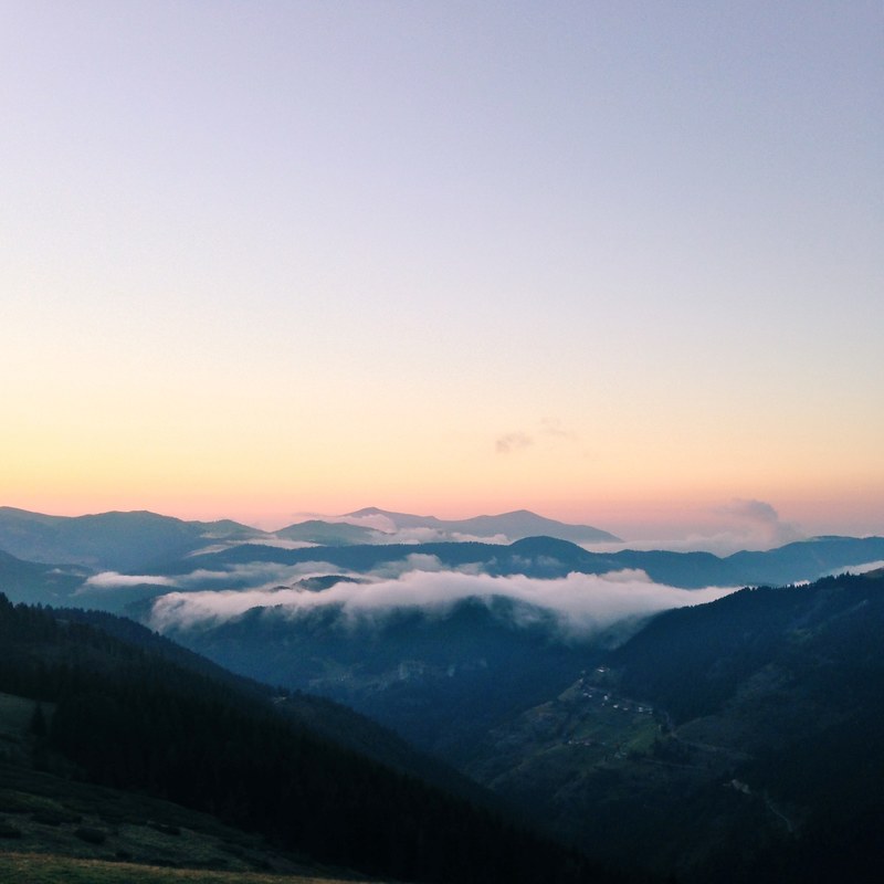 clouds gathering over a mountain valley in the evening, gathering clouds at dusk 4k