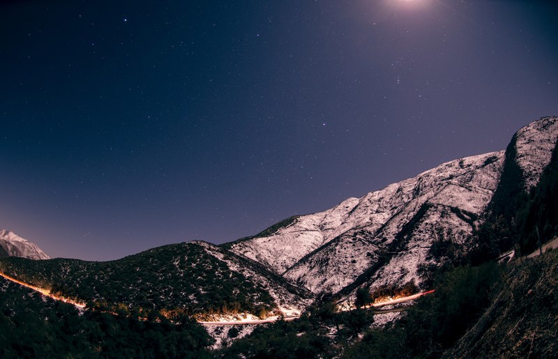 lights from cars driving on a mountain road in san diego illuminate the path, san diego mountains at night 4k