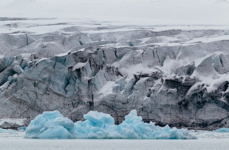 ice glaciers in the water and snow covered rock formations in the background in svalbard, svalbard glacier 4k