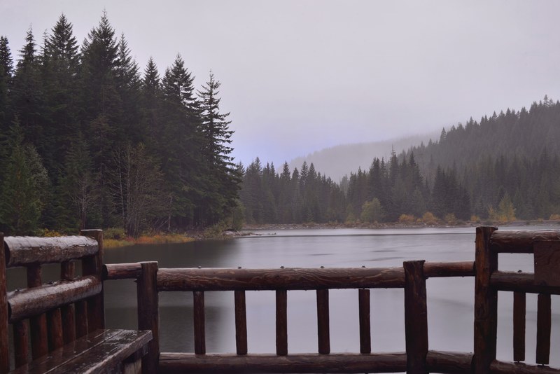 wooden railing over a lake on a cold autumn day, lake seen from a wooden platform 4k