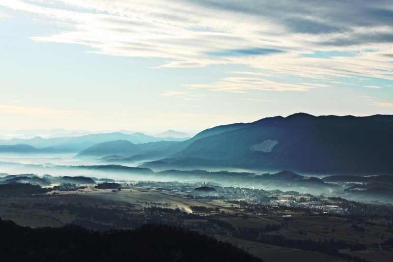 a town in a valley surrounded by rolling fog, valley town 4k