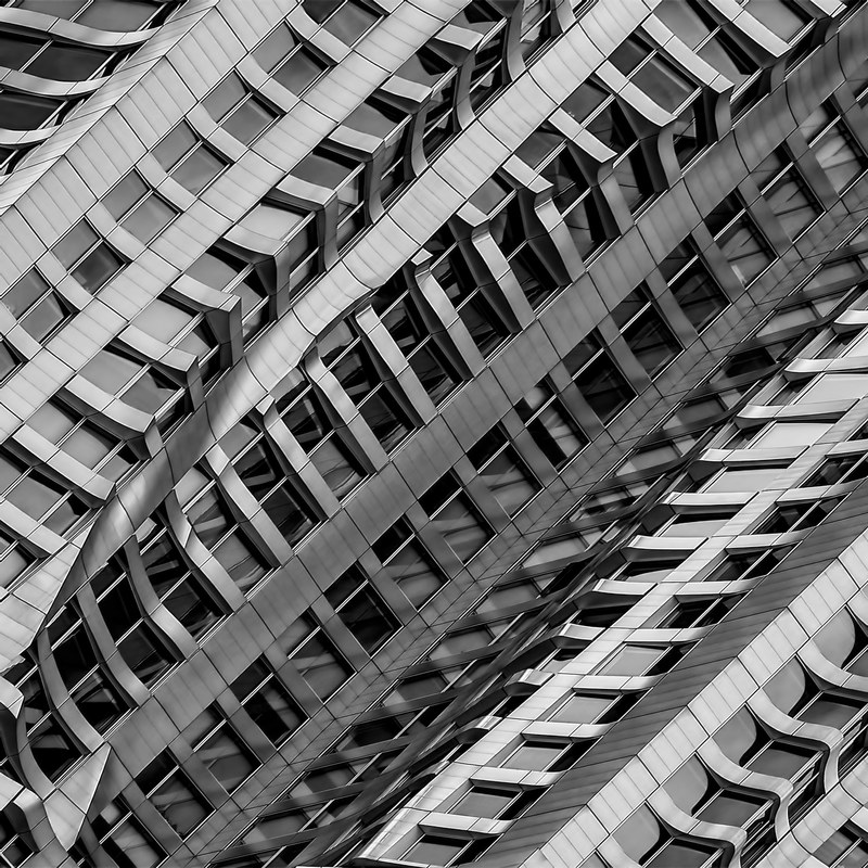an angular black and white shot of a modern skyscraper, metal diagonal 4k