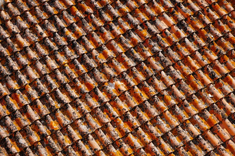 old terracotta clay tile in vertical rows on a house roof, terracotta clay tile 4k