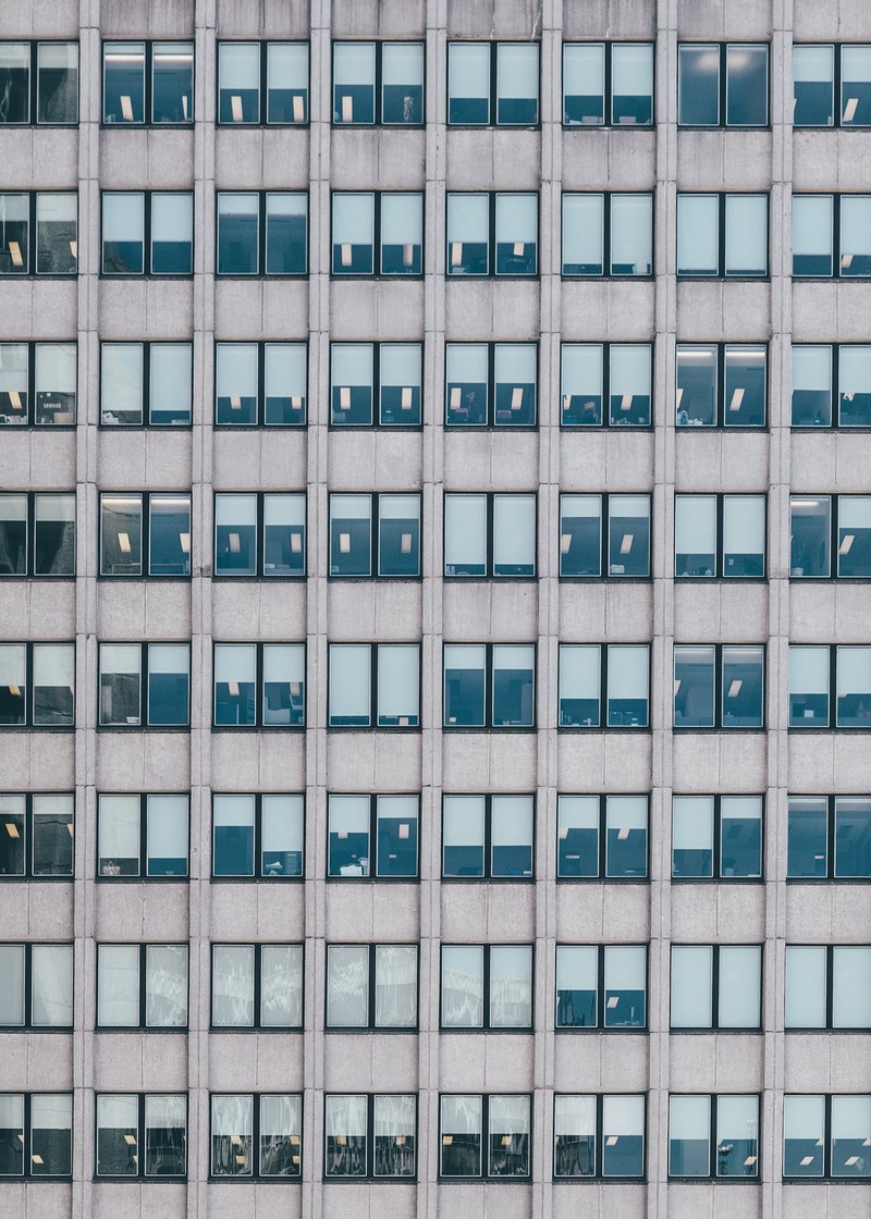 an office building in memphis with symmetrical gray textured walls and double windows, _office building memphis 4k