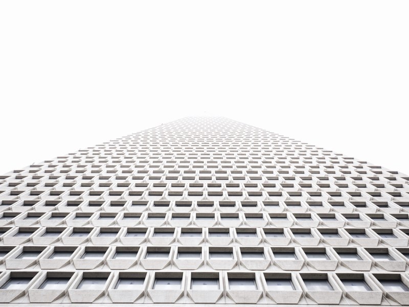 a low angle shot of a towering building with a white facade, towering white facade 4k