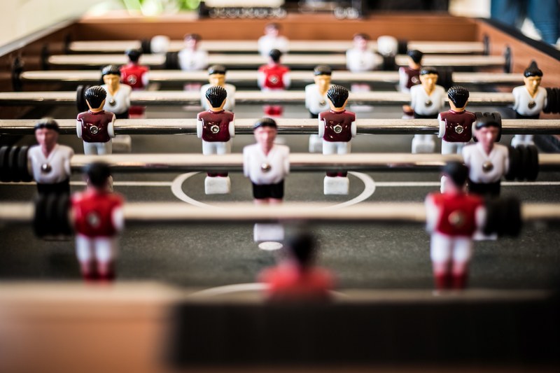 red and white jersey figures on rotating bars of the table soccer at bornerbroeksestraat 2, soccer table game netherlands 4k