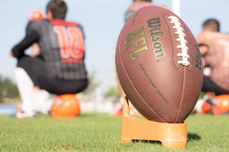 macro view of a wilson nfl football ball with a stand at the pontifcia universidade catlica do the rio grande do sul, rugby ball in the field 4k