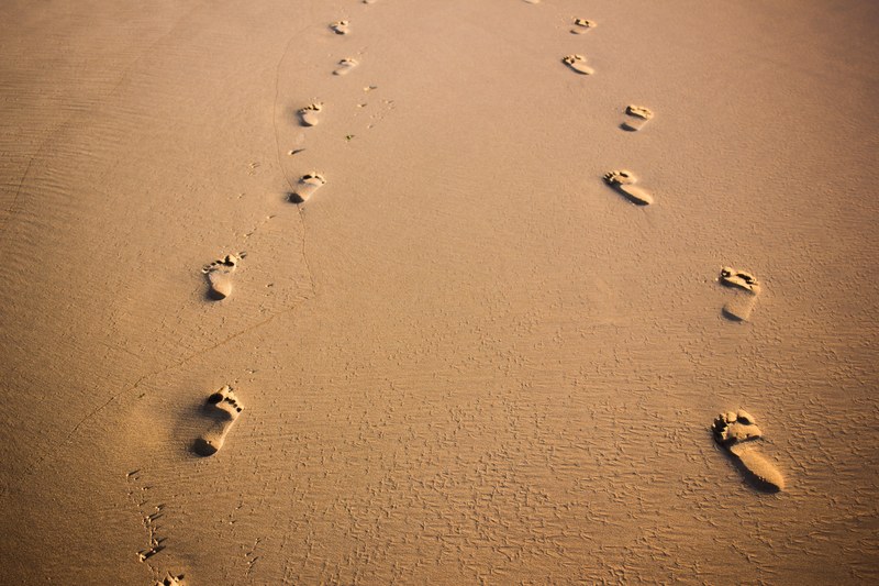 footprints sand beach and desert 4k
