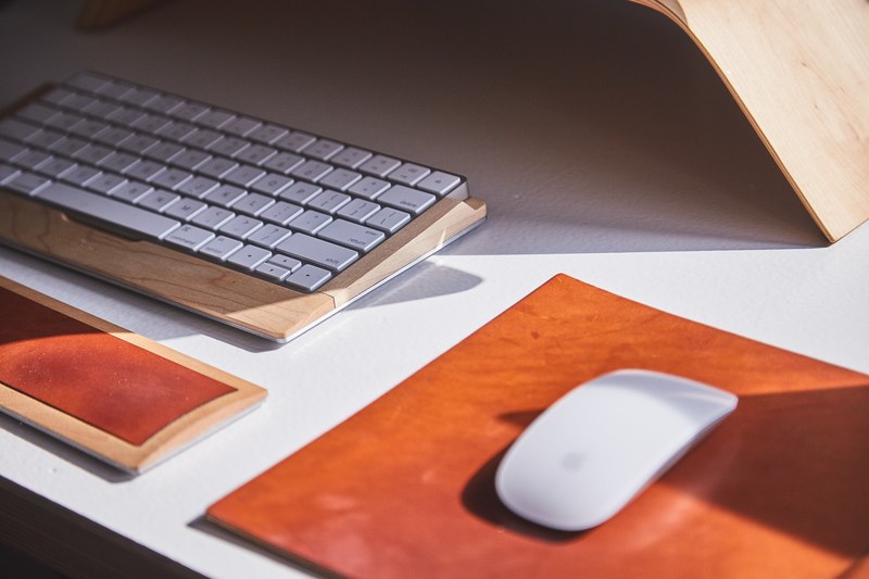 an apple mouse and keyboard in a wooden casing on a desk, apple mouse and keyboard 4k