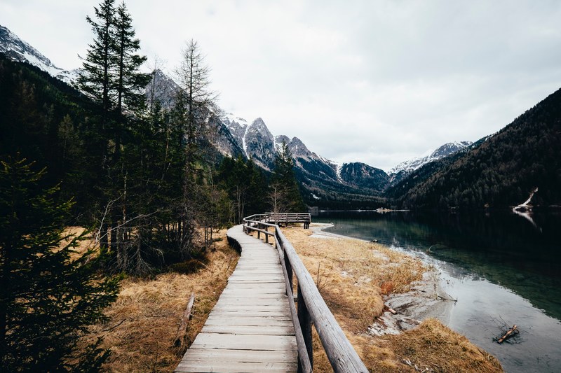the snowcapped mountains a stream the forest and a path in antholzer see, antholzer see mountains 4k