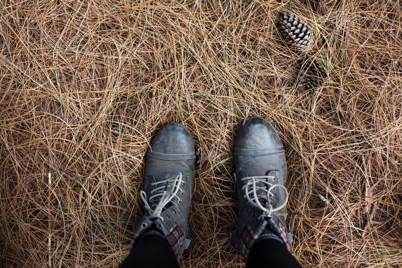 a man looking down at his laced shoes in pilgrims rest campground, staring at own shoes 4k
