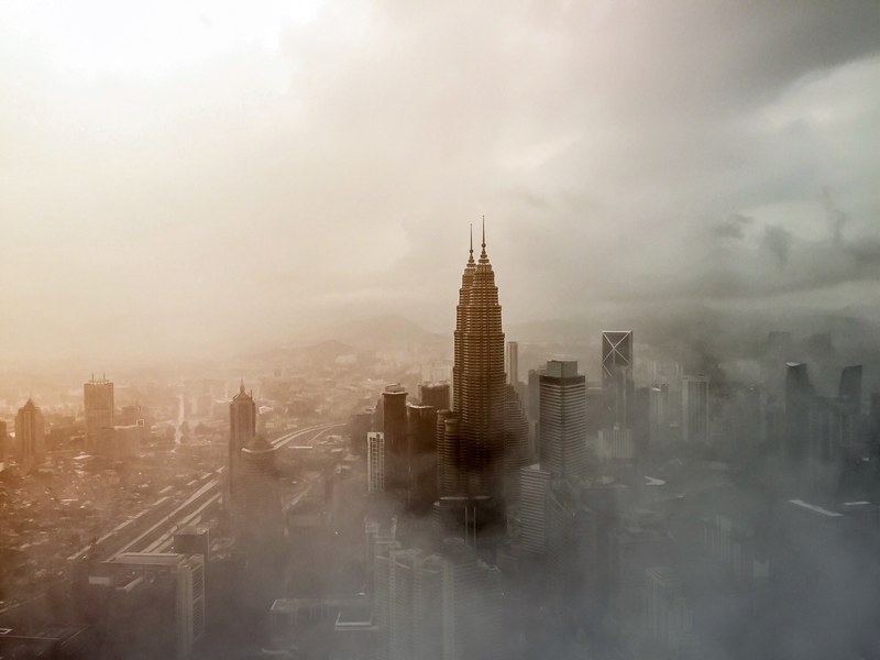 tall skyscrapers in kuala lumpur wreathed in a dense fog, klcc 4k