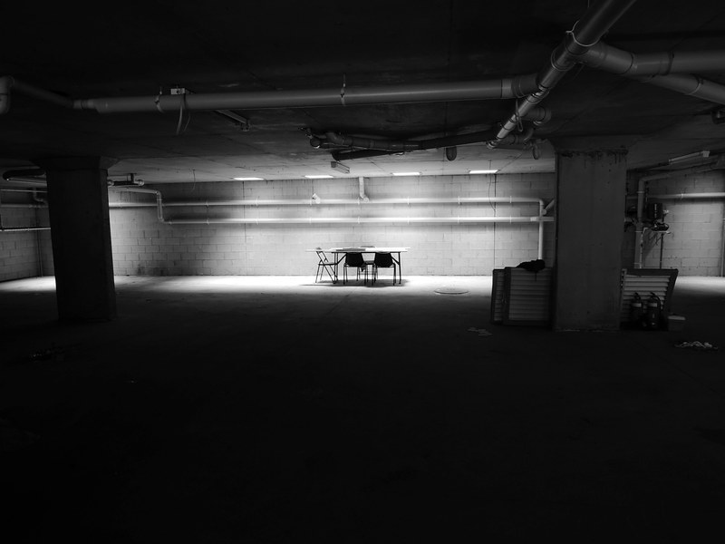 an empty table with chairs in a dark basement, basement chairs and tables 4k