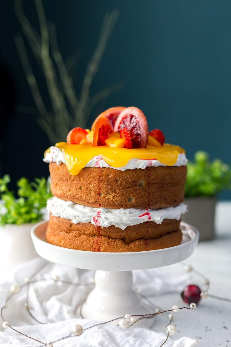 naked tiered cake topped with frosting and fruit, blood orange chiffon cake with mango curd 4k