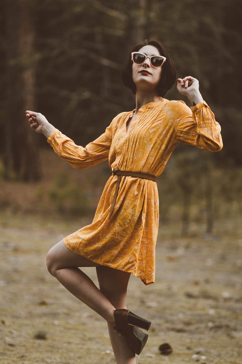 woman in a yellow dress dances confidently in the desert, trina 4k
