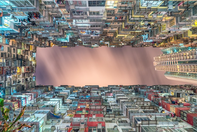 view from the bottom of a cramped residential building courtyard at night, cramped housing 4k