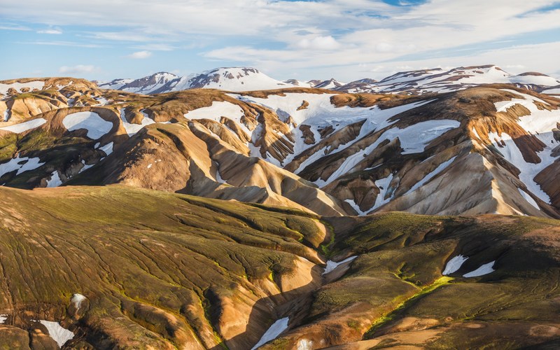 folded mountain slopes covered with patches of snow in landmannalaugar, on the laugavegur trek iceland 4k