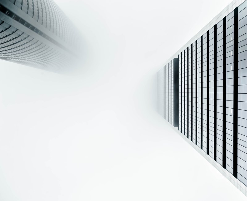 looking up at city buildings on a foggy day in madrid, into the fog 4k