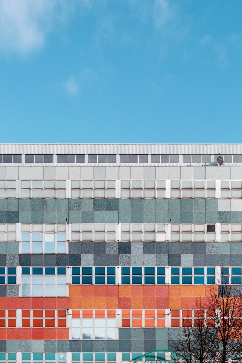 a colorful apartment building with square tiles in various colors on its facade in berlin, colorful tiles on a facade 4k