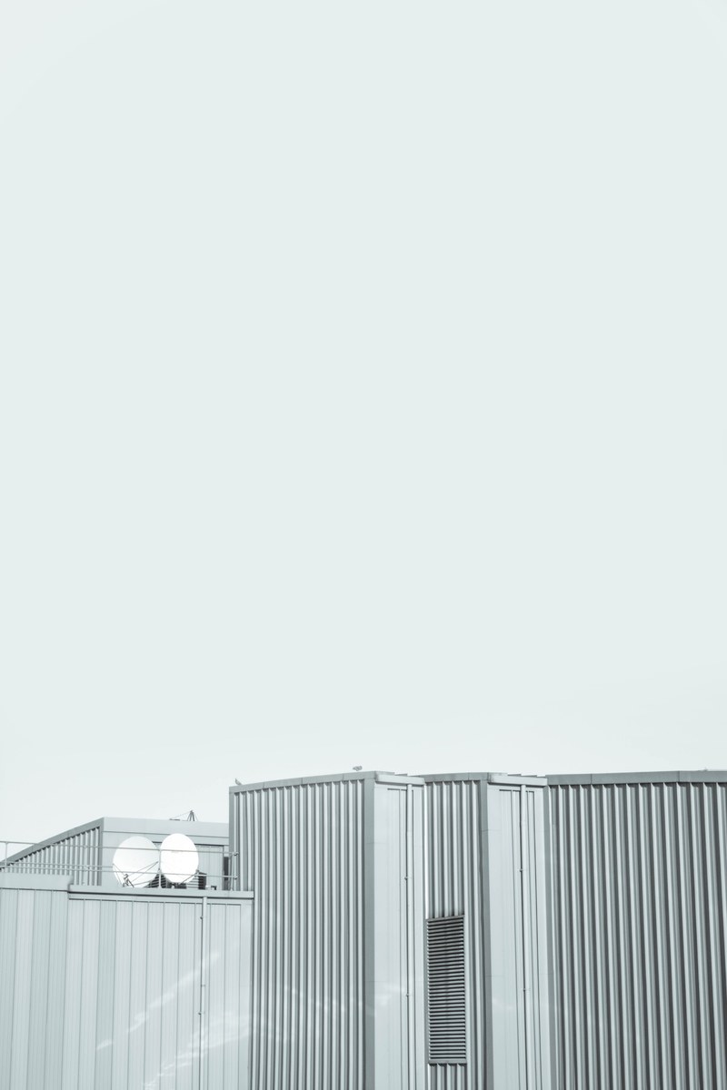 gray walls of an industrial building under a white sky, gray industrial building 4k
