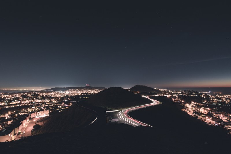 a cityscape image of twin peaks featuring a light trail timelapse on a local road, twin peaks 4k