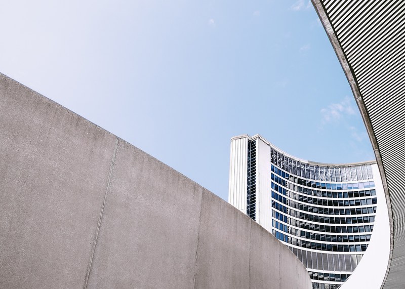 concrete walls near the curved building of toronto city hall, concrete city hall plaza 4k