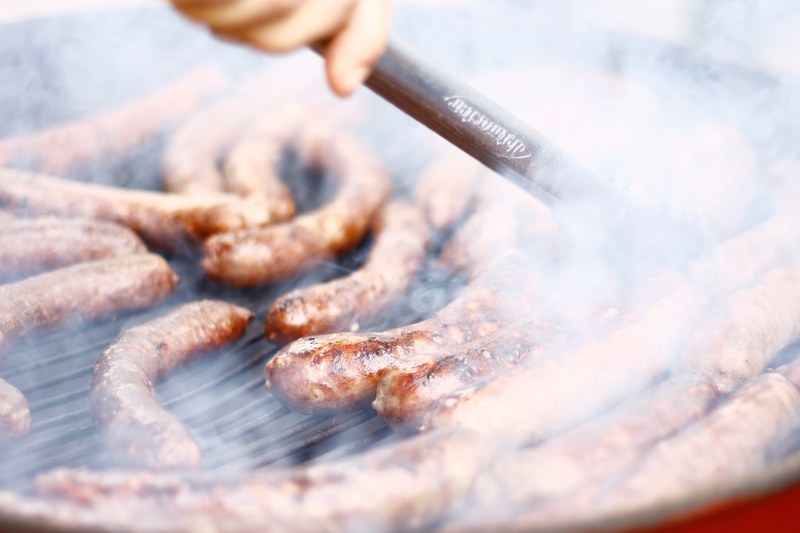 grilling smokey sausages and brats on a grill, grilling sausages 4k