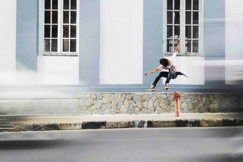 skateboarder doing a skate trip on a city street, skate trick 4k