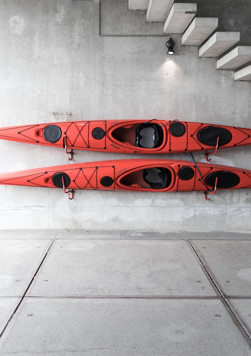 two red kayaks mounted on the wall of a postmodern house, _red kayaks on a wall 4k