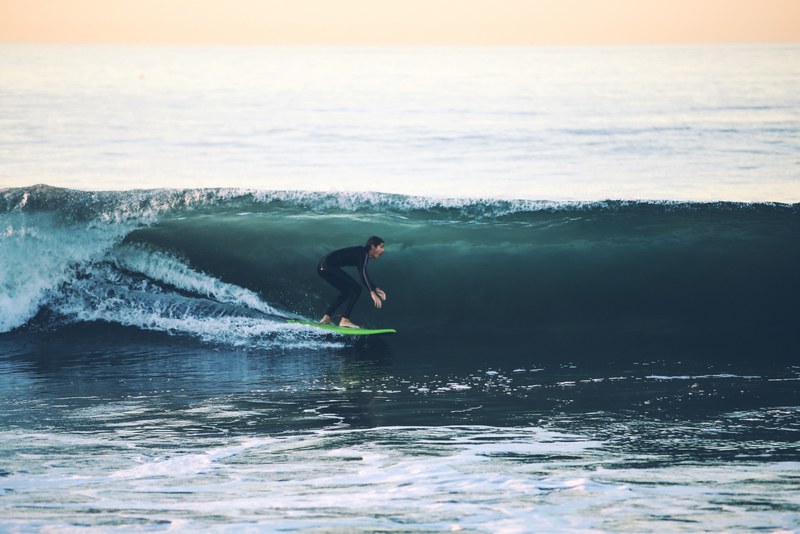 surfer surfing on the ocean wave at 54th street, riding the rolling wave 4k