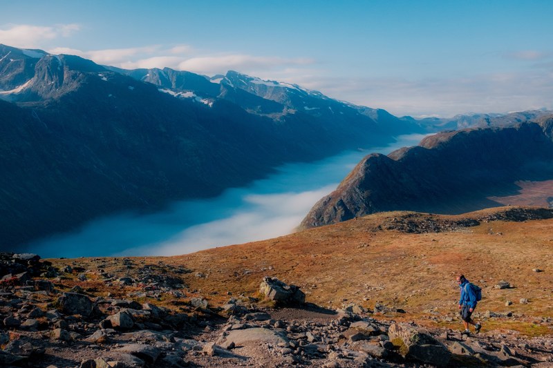hiker walks alone through deserted rocky valleys near mountains, hiking alone 4k
